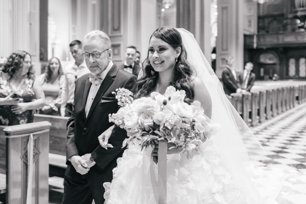 Bride walking down the aisle during her Spring church wedding