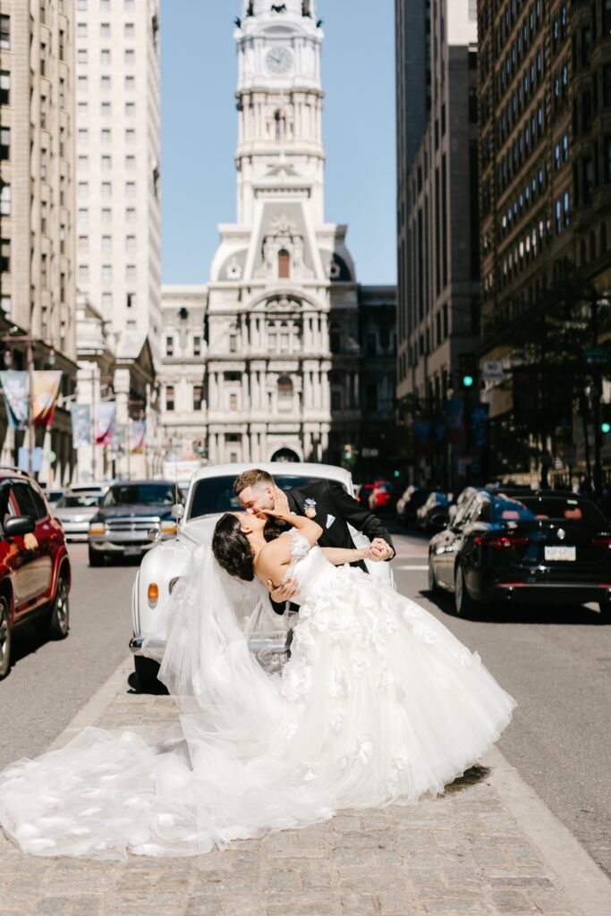 Bride and Groom kissing in front of Philadelphia's City Hall