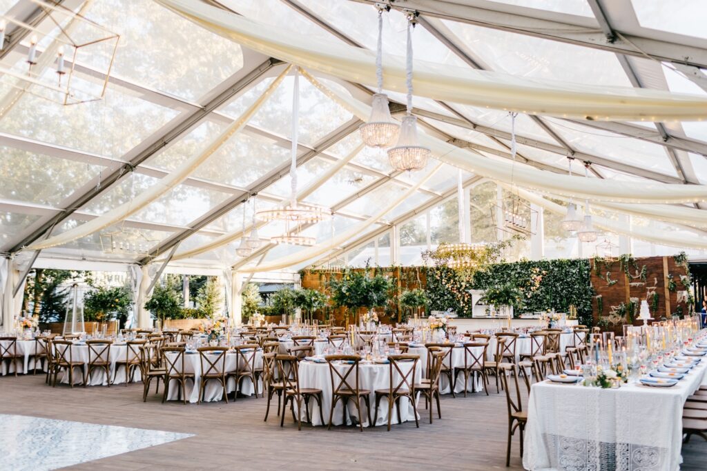 Wedding reception with a Clear Top Tent and Chandeliers
