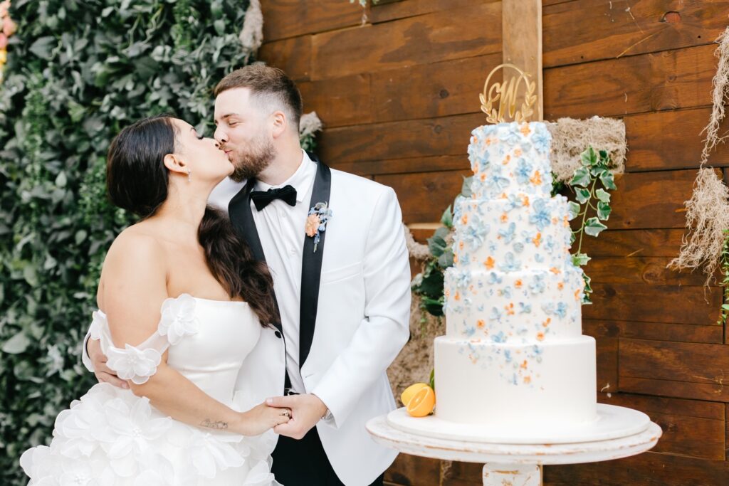 Bride and groom with their four tier cake at their Spring Philadelphia wedding