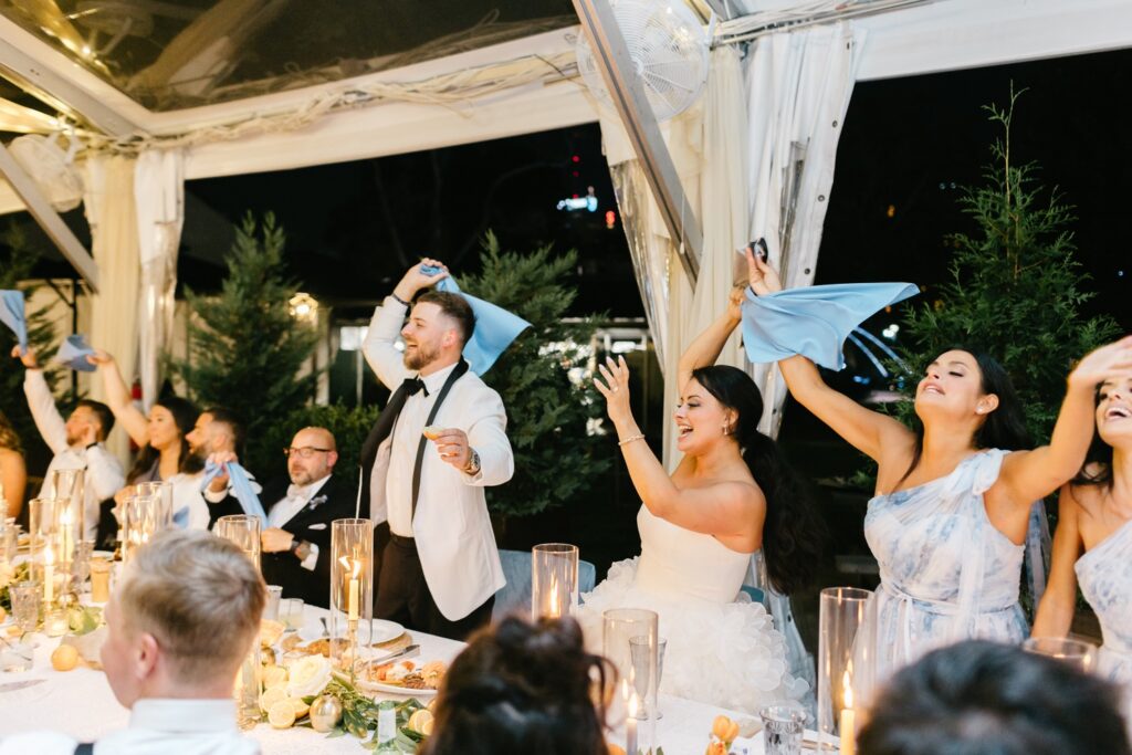 Bride and Groom cheering during their Italian Inspired Wedding Reception