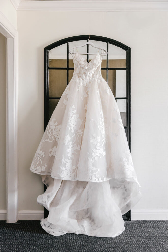elegant bridal gown with floral details along the skirt