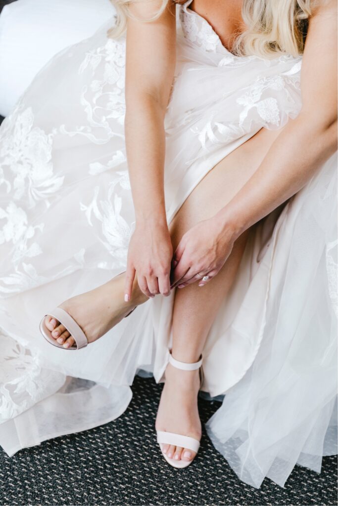 The bride putting on Christian Louboutin heels for her Philadelphia winter wedding day