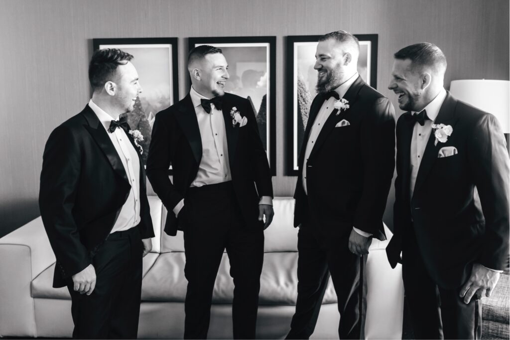 Groom laughing with groomsmen before the Philadelphia wedding ceremony in Fairmount neighborhood