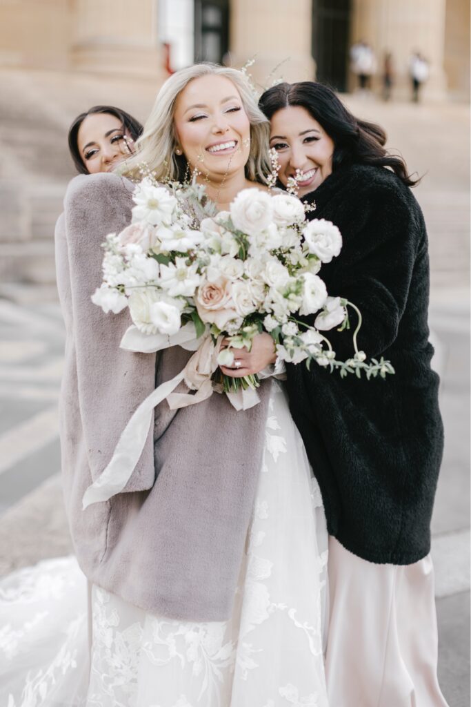 bride with her bridesmaids during their portrait session During her winter wedding day