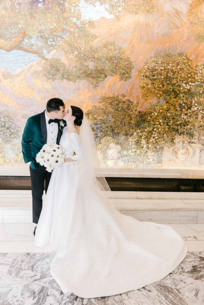 bride and groom in front of painted portrait background in Old City Philadelphia