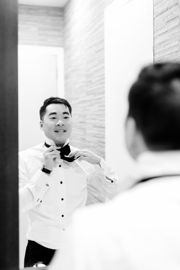 groom getting ready for his winter wedding in Center City Philadelphia by Emily Wren Photography