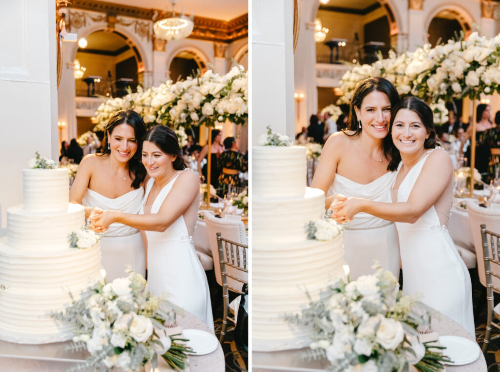 lesbian couple cutting their 4 tier all white minimalistic wedding cake during Center City wedding reception