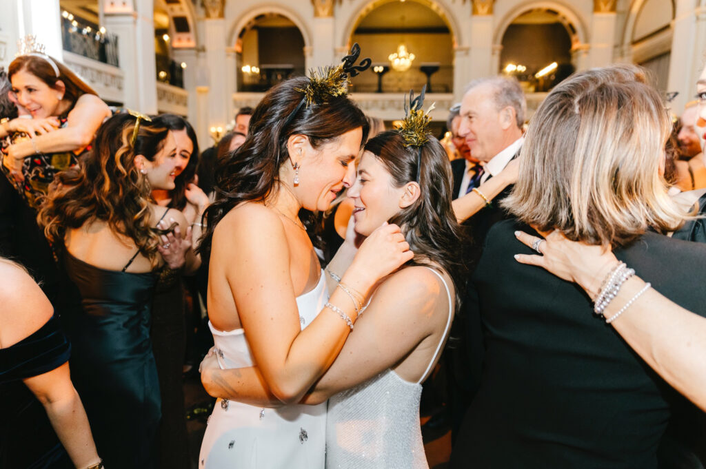 lesbian couple celebrating at their New Years Eve wedding reception at Ballroom at the Ben in Philadelphia by Emily Wren Photography