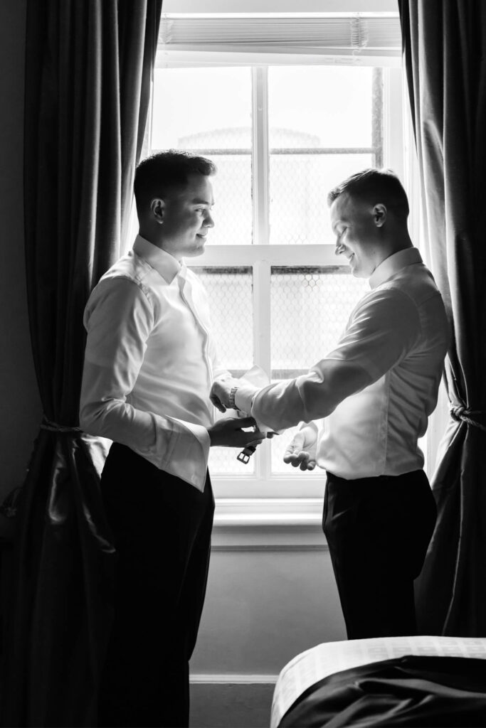 same sex grooms getting ready together for their winter city wedding