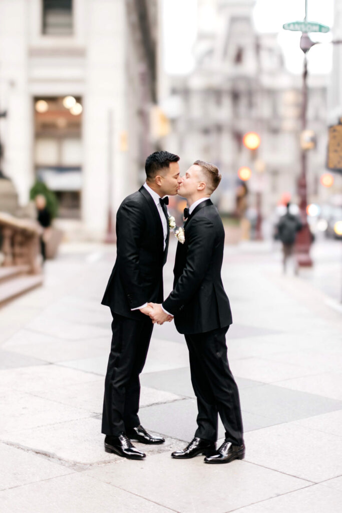 gay wedding couple on Broad St in Philadelphia in front of City Hall by Pennsylvania Wedding Photographer Emily Wren Photography