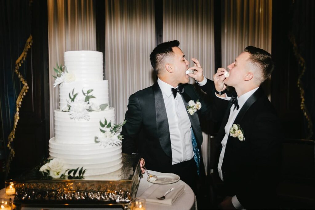 grooms trying their wedding cake at The Kimmel Center wedding reception