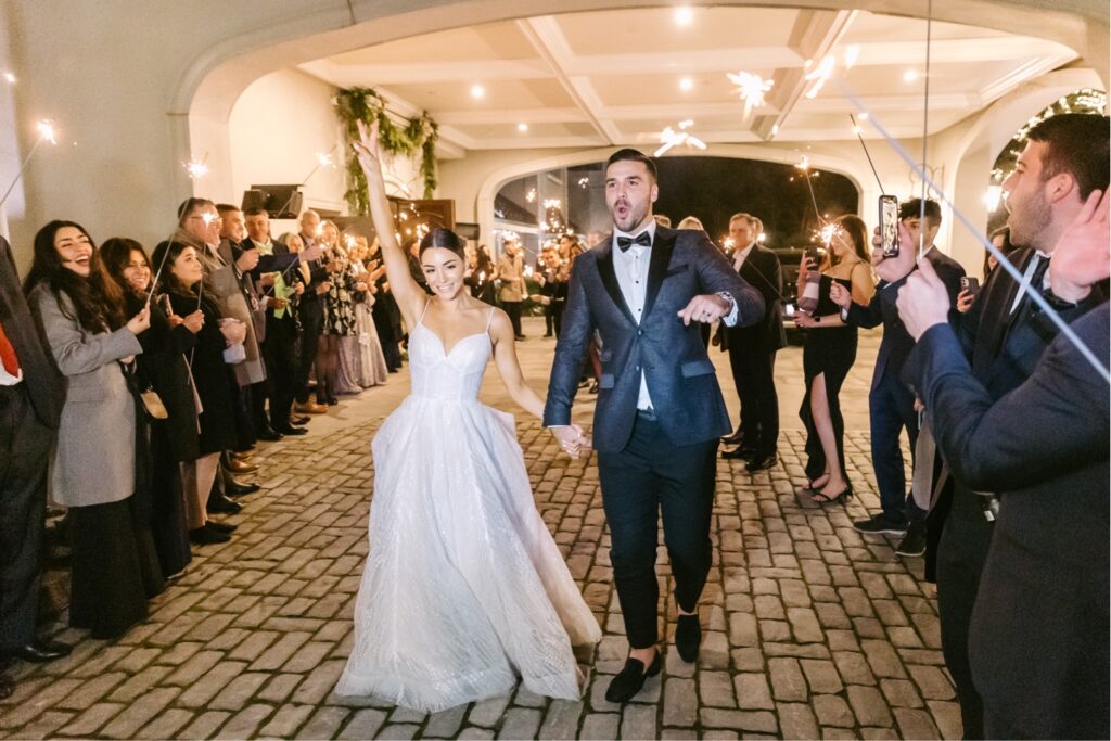 bride and grooms exit from their winter wedding reception at Park Chateau By Emily Wren Photography