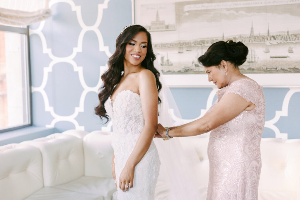 The mother of the bride, helping her get into her bridal gown in Center city Philadelphia