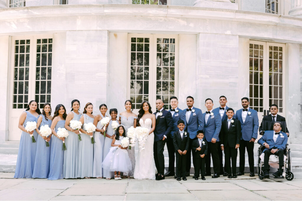 Bridal party dressed in blue at merchants exchange in Philadelphia on a summer wedding day