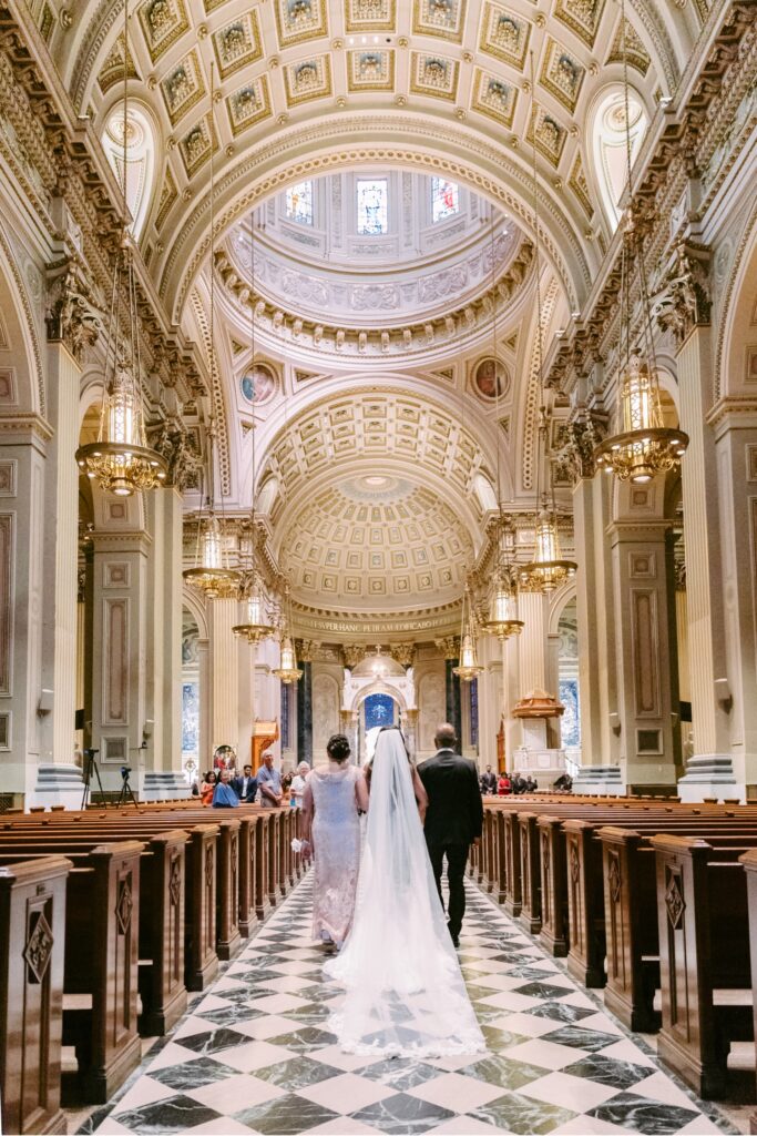 Bride walking down the aisle at basilica of Saints Peter & Paul