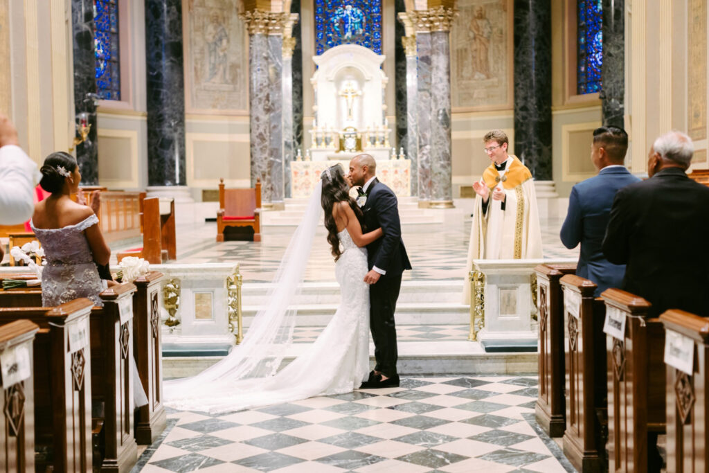 Bride and groom at Basilica of Saints Peter and Paul during their wedding ceremony in the summer wedding ceremony