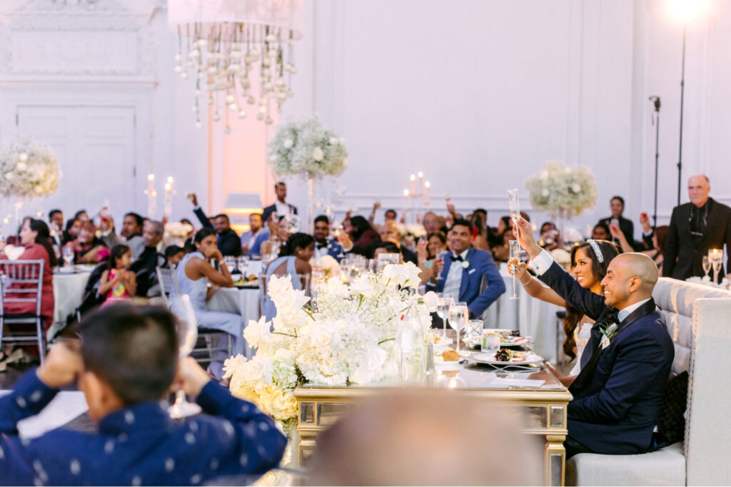 Guests toasting at a Cescaphe summer wedding reception