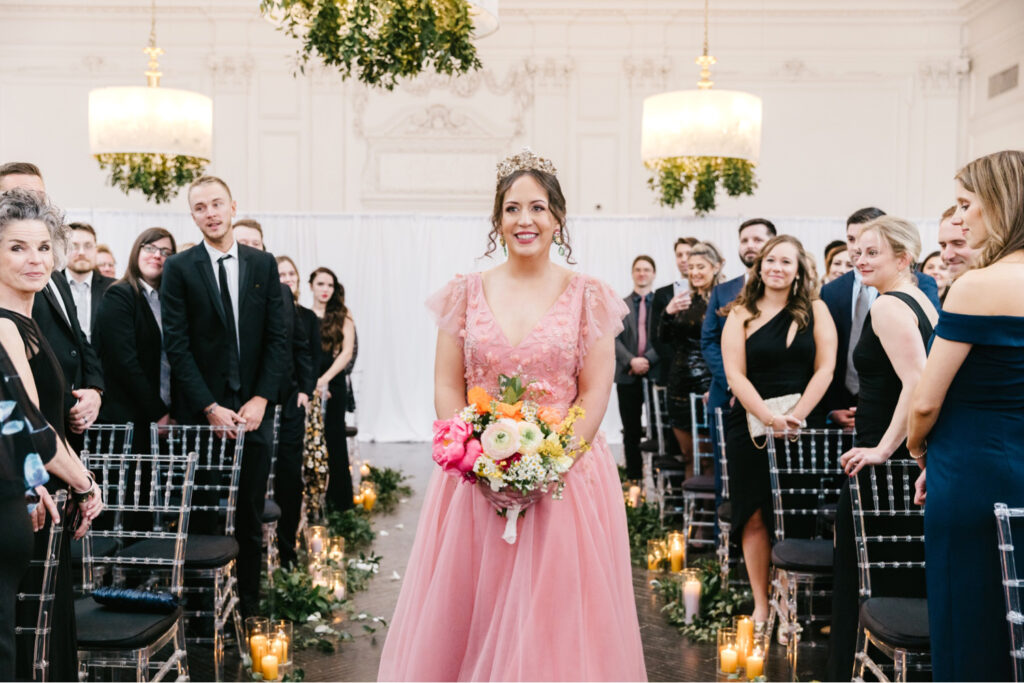 bride walking down the aisle in her pink wedding dress for her spring wedding day