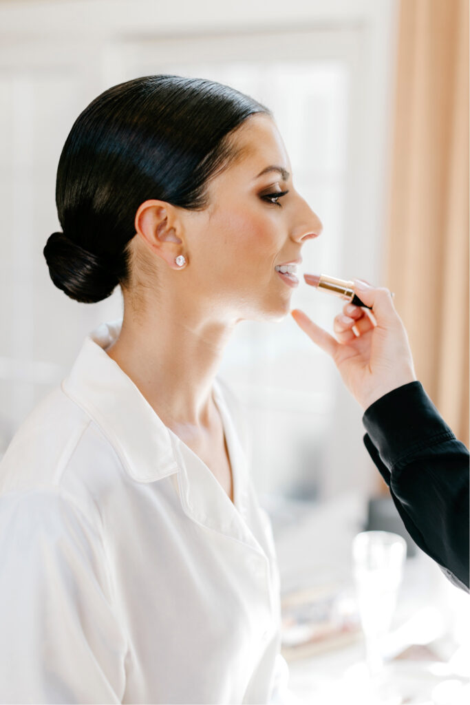 bride getting her makeup down for her Winter wedding in her New Jersey Home