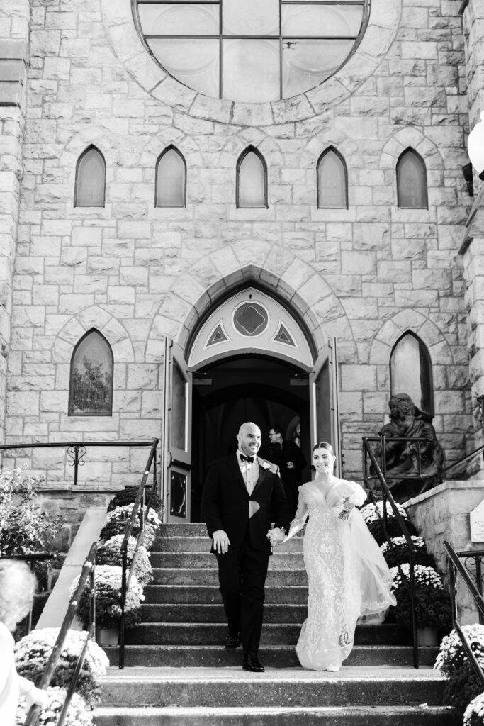 bride and groom exiting Our Lady of Good Counsel Church in Moorestown New Jersey by Emily Wren Photography