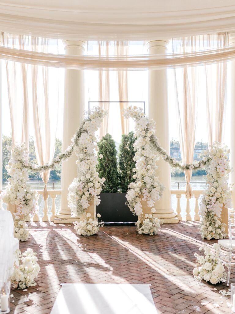 All white stylish floral arch for wedding ceremony at Philadelphia Water Works