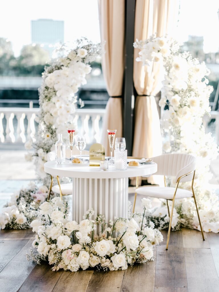 all white floral wedding reception arrangement