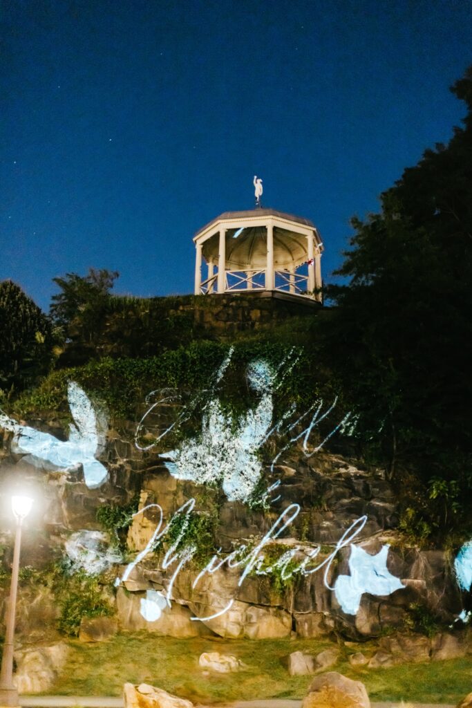 outdoor projection of bride & grooms names at Philadelphia Water Works wedding by Emily Wren Photography