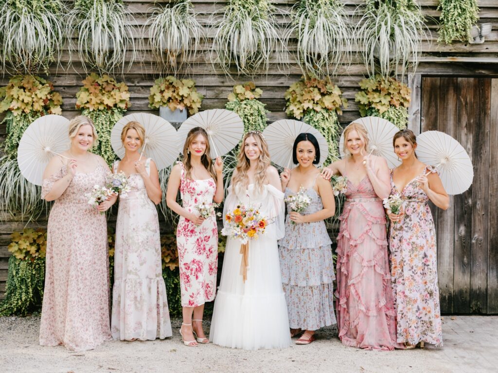 bride with her bridesmaids in mis matched summer dresses at Terrain at Styer's