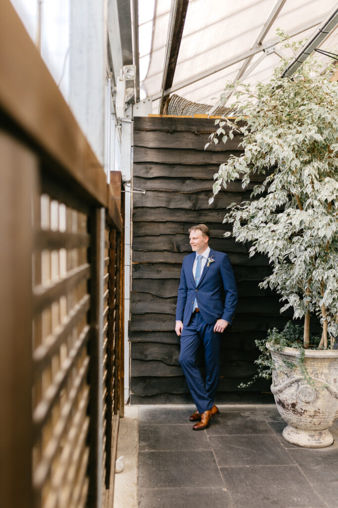 portrait of groom before Summer garden wedding