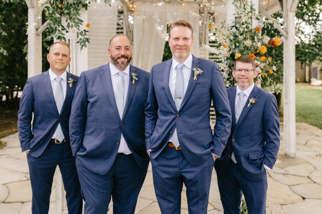 groom with groomsmen in navy tux's for colorful summer wedding