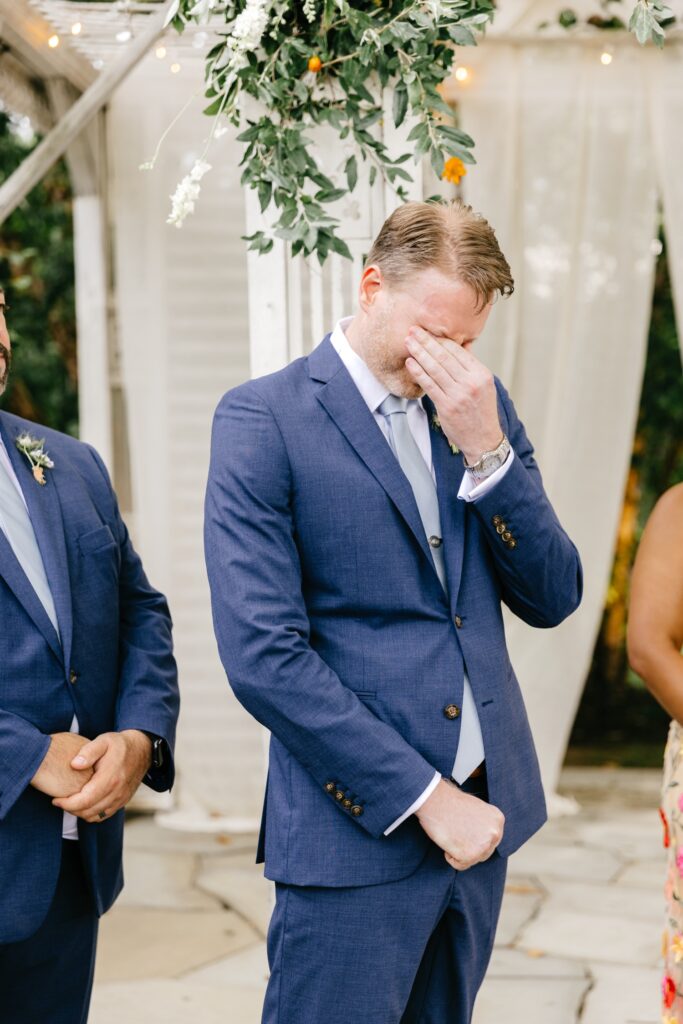 grooms reaction to bride walking down the aisle at outdoor summer wedding ceremony by Emily Wren Photography