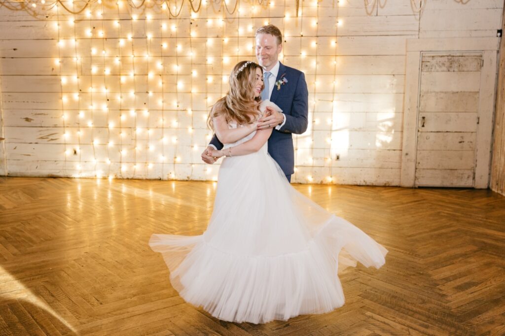 bride & groom's first dance in front of twinkle light wall at Terrain at Styer's in Pennsylvania by Emily Wren Photography by Emily Wren Photography