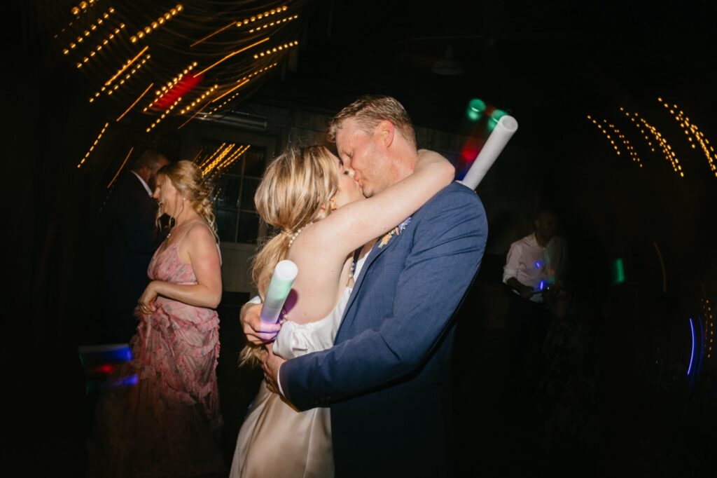 bride & groom kissing at their summer wedding reception by Pennsylvania wedding photographer Emily Wren Photography