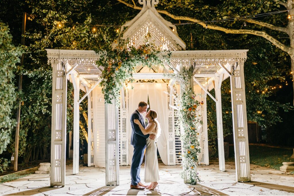 bride & groom in Pennsylvania garden under twinkle light canopy