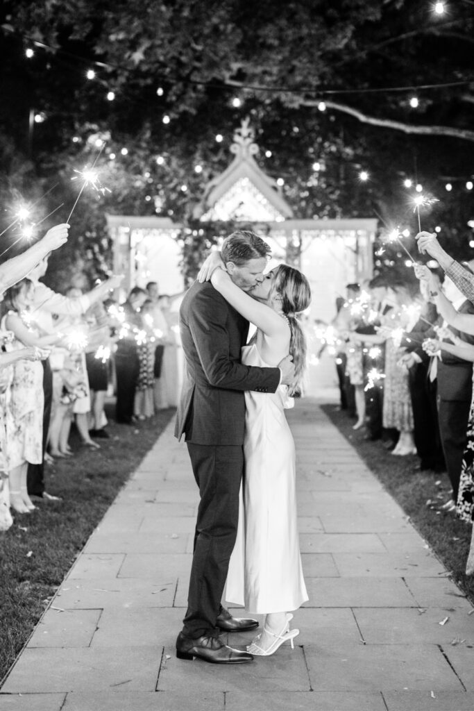 bride & groom kissing at sparkler wedding reception exit at Terrain at Styers by Emily Wren Photography