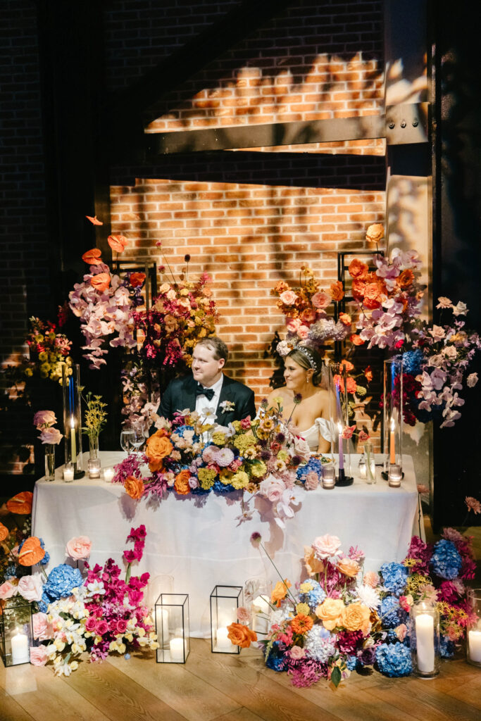 Vibrant & moody sweetheart table during Philadelphia wedding reception by Emily Wren Photography