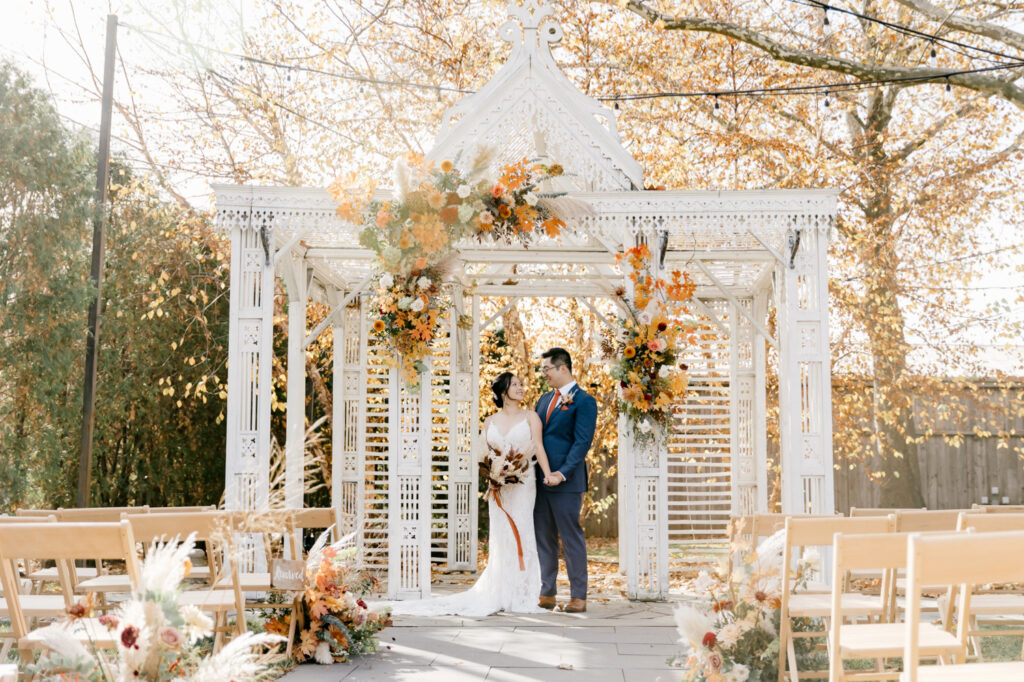 bride & groom portrait under white whicker gazebo in Pennsylvania