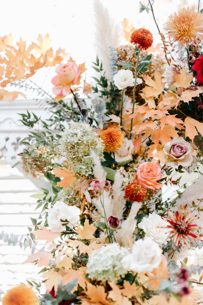 fall wedding floral details of pink, orange, red & white flowers