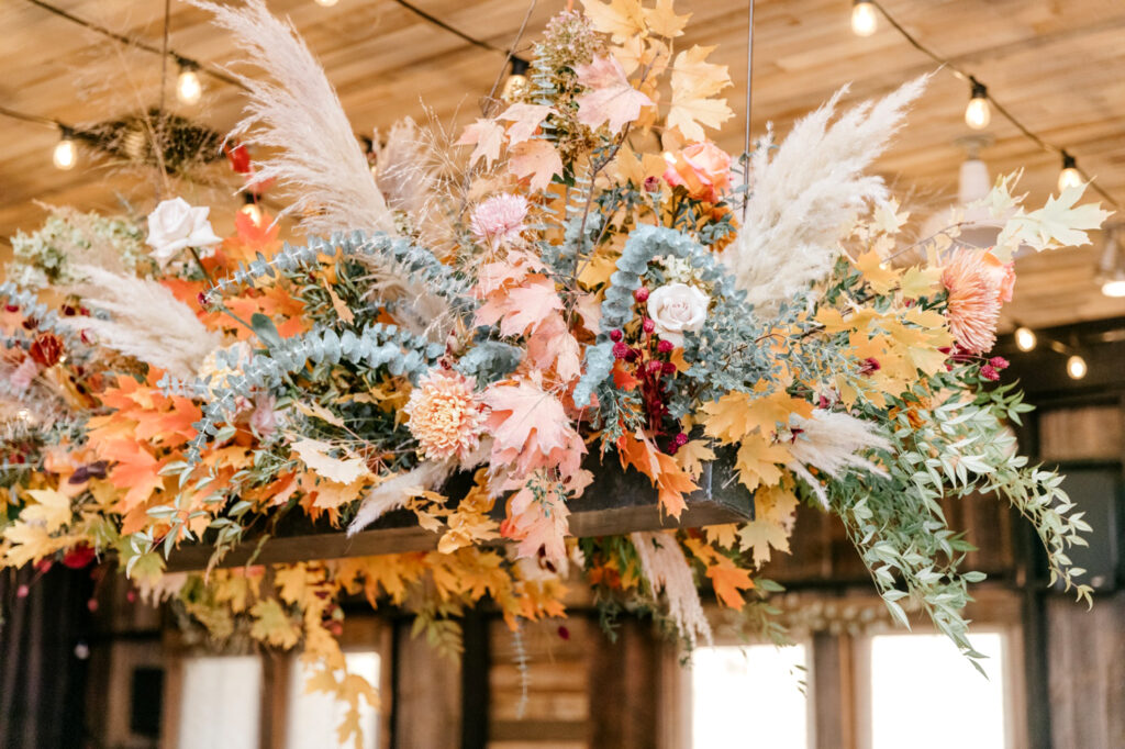 fall foliage ceiling floral display at Terrain wedding event by Emily Wren Photography