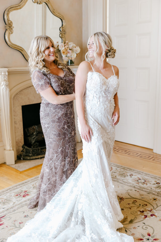 bride getting dressed at Glen Foerd Mansion for her summer wedding day