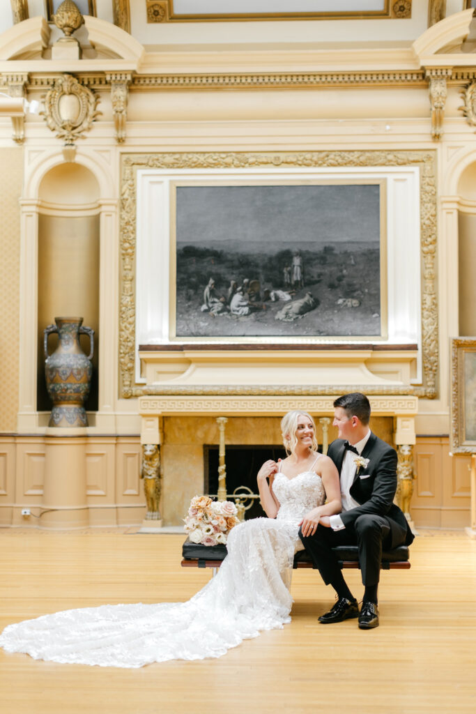 bride & groom with paintings & artwork at Glen Foerd in Philadelphia