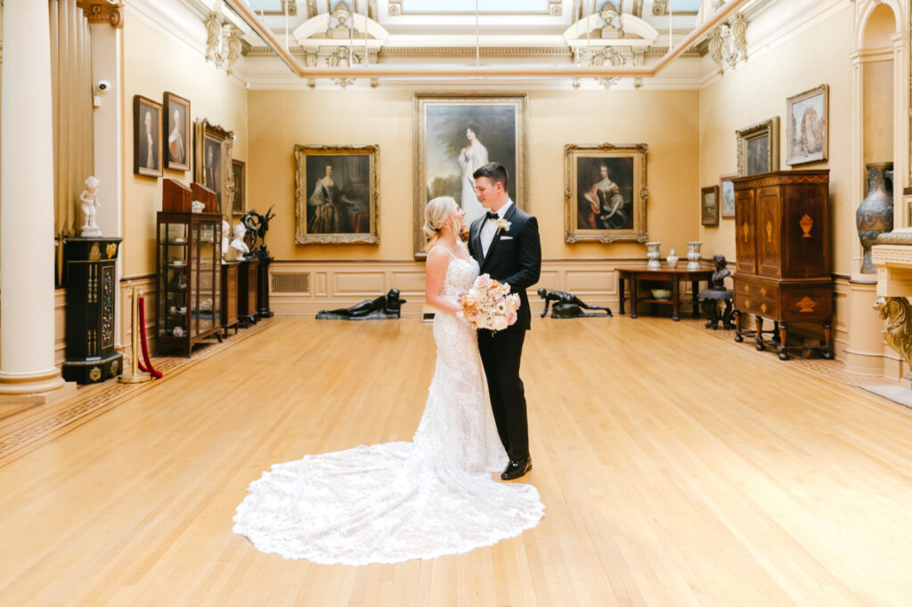 bride & groom in front of historical paintings at Glen Foerd Mansions by Emily Wren Photography