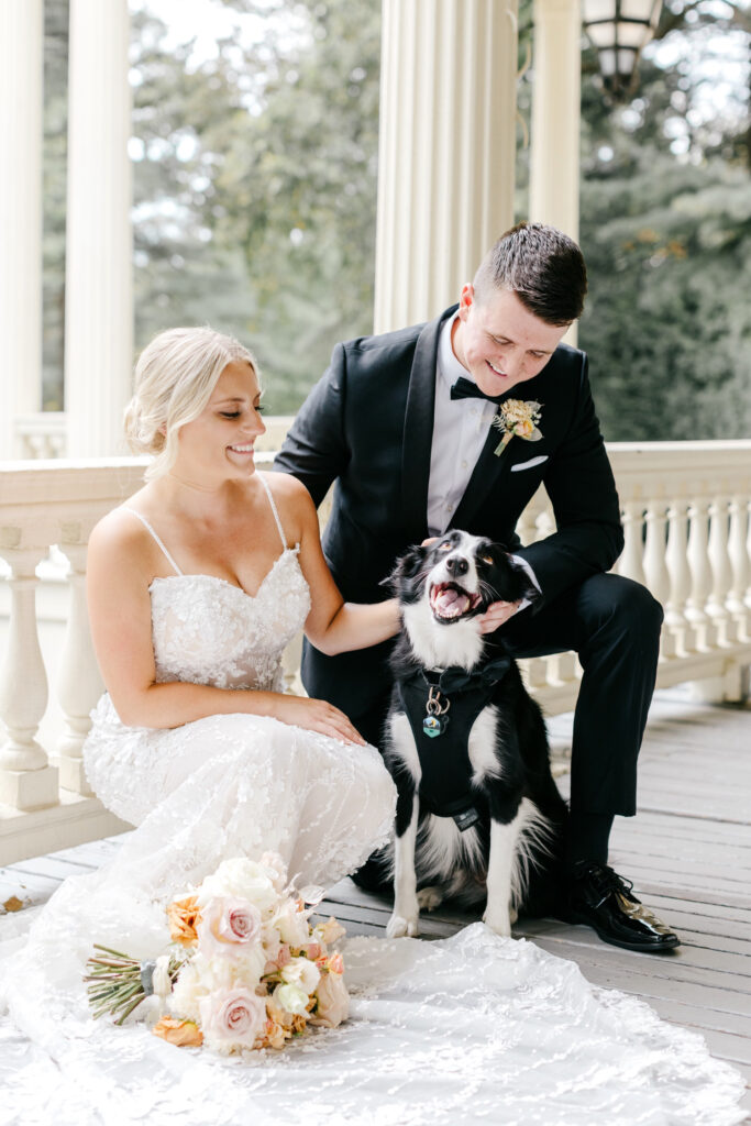 bride & groom with their dog at Glen Foerd in Philadelphia, Pennsylvania