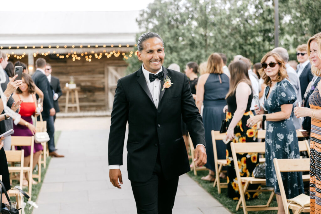 groom walking down the aisle at Terrain at Styers