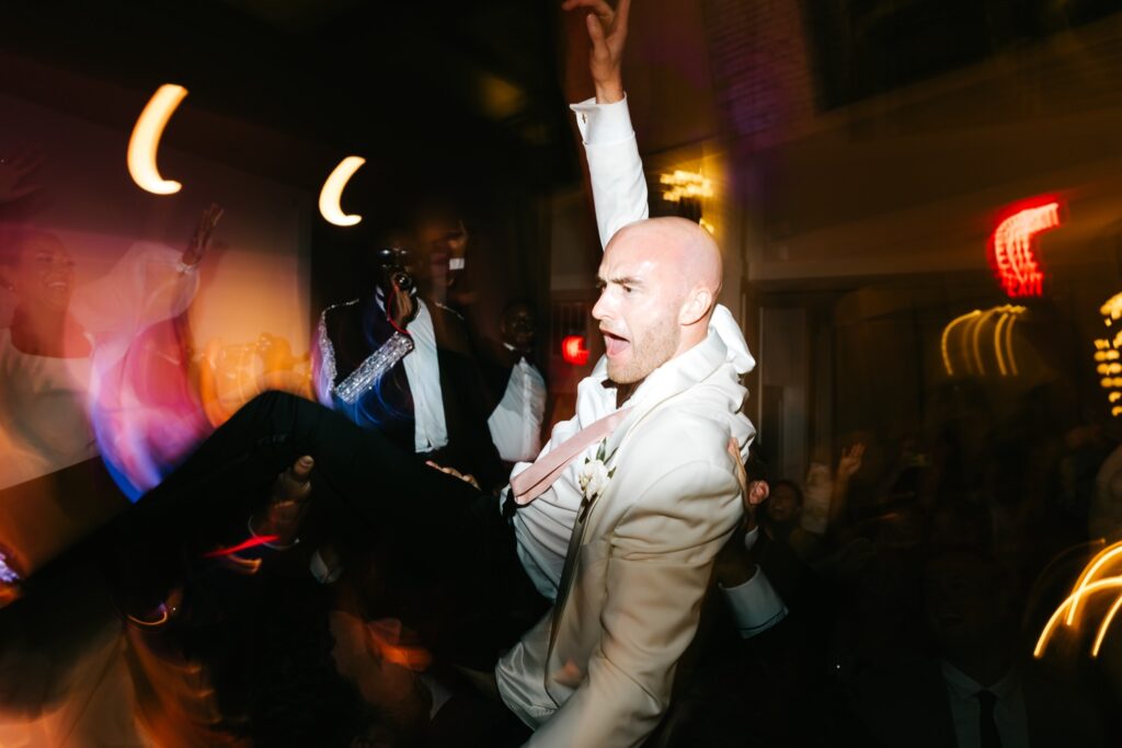 groom having fun during Philly wedding reception by Emily Wren Photography