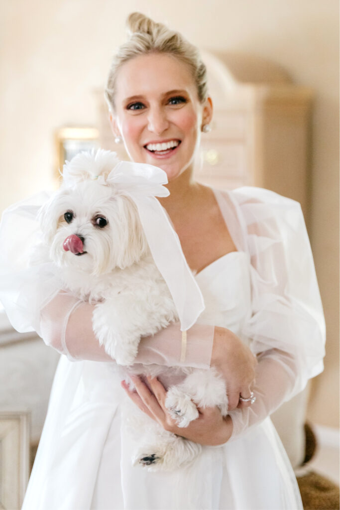 bride with her dog dressed in bridal veil