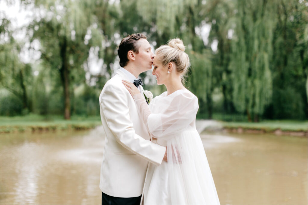 bride and groom by a pond in Pennsylvania by Emily Wren Photography