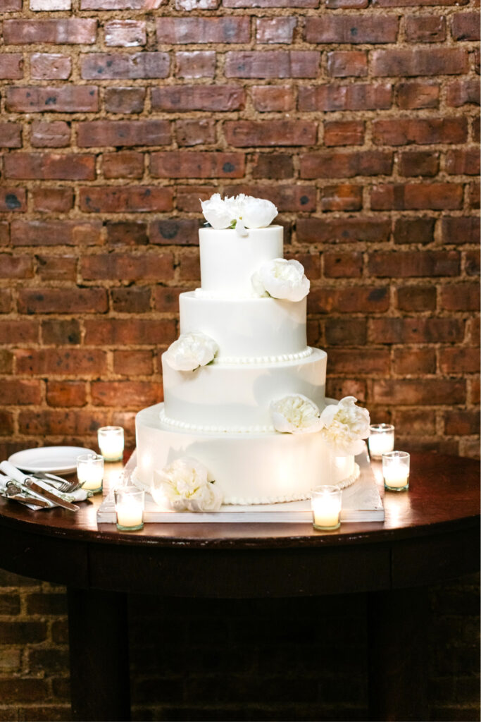 4 tier wedding cake with white floral decor