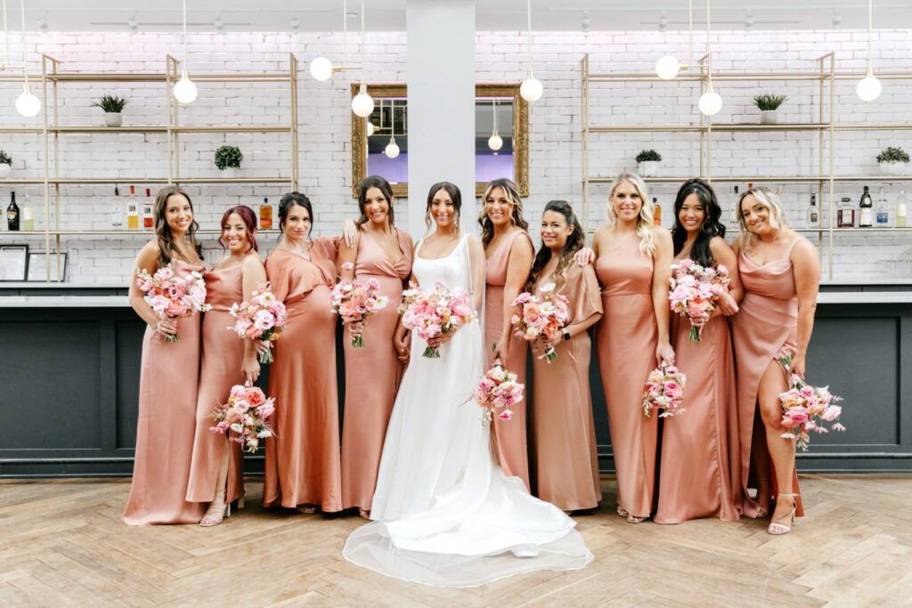 bride with bridesmaids dressed in pink bridesmaid dresses